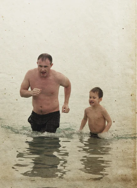 Father and son on spring sea. Photo in old color image style. — Stock Photo, Image