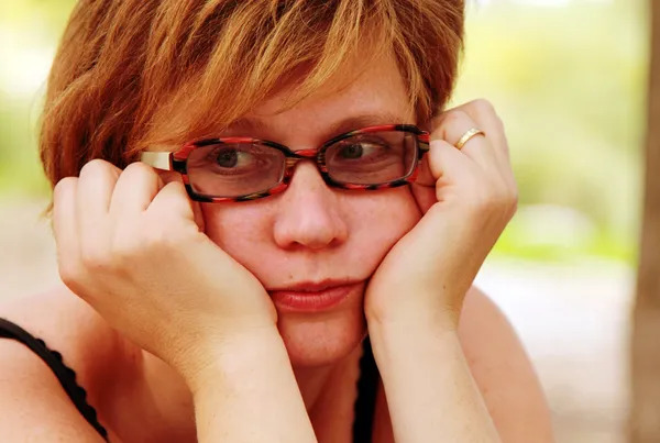 Close up portrait of sad redheaded woman — Stock Photo, Image