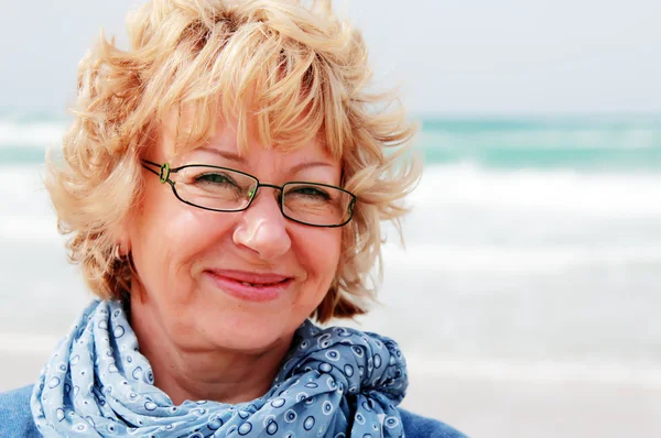 Portrait of happy senior woman at sea — Stock Photo, Image