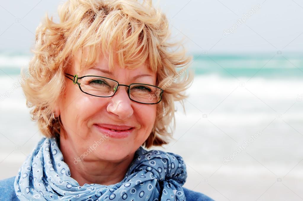 Portrait of happy senior woman at sea