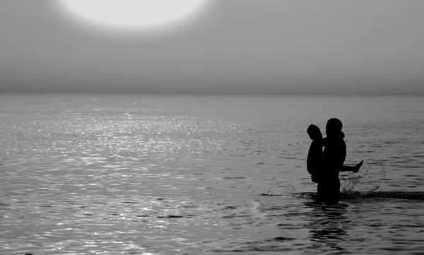 Father and son swimming in the sea — Stock Photo, Image