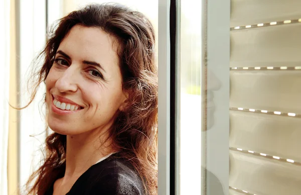 Portrait of beautiful 35 years old woman next to the window — Stock Photo, Image