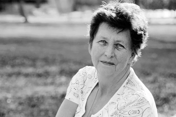 Portrait of 65-years-old beautiful woman outdoors. Beauty and w — Stock Photo, Image