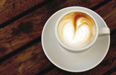 Tahta arka planda bir fincan kahve.