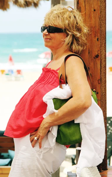 Happy beautiful senior woman on summer vacation at sea — Stock Photo, Image