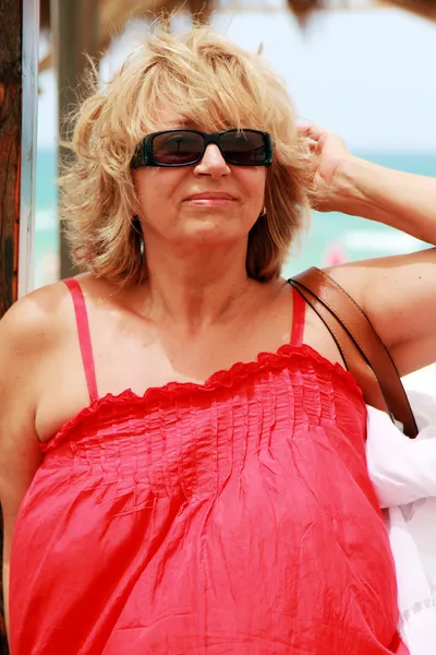 Happy beautiful senior woman on summer vacation at sea — Stock Photo, Image