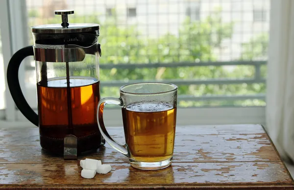 Cup of tea standing on small wooden table — Stock Photo, Image