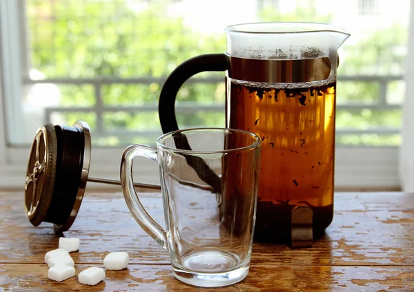 Cup of tea standing on small wooden table — Stock Photo, Image