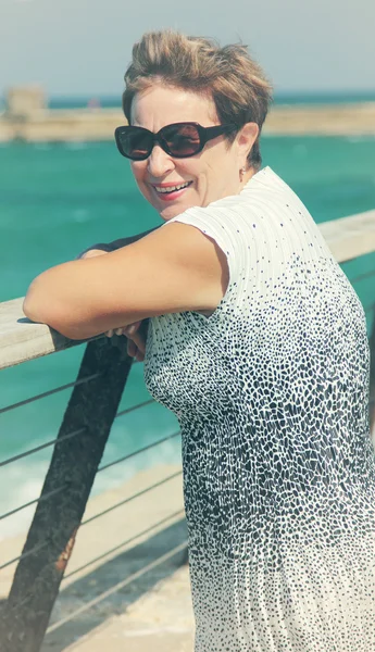 Happy mature woman walking near the sea — Stock Photo, Image