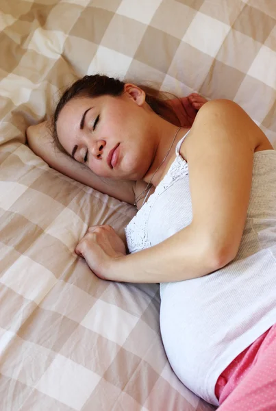 Sleeping pregnant woman on the bed — Stock Photo, Image