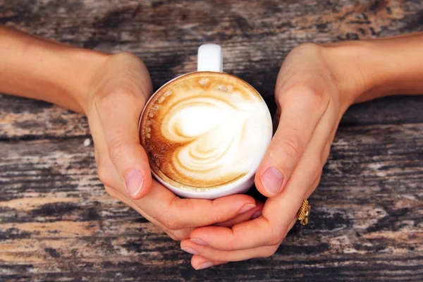 Woman holding cup of coffee — Stock Photo, Image