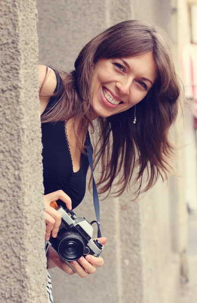 Smilling woman with camera — Stock Photo, Image