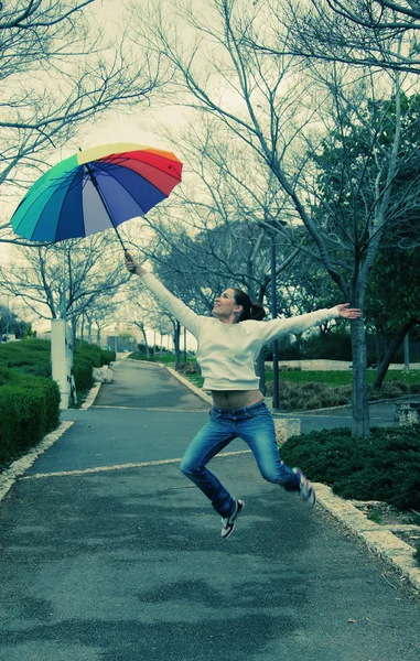 Woman jumpimg with umbrella — Stock Photo, Image