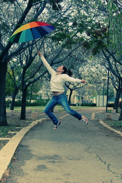 Woman jumps with umbrella — Stock Photo, Image