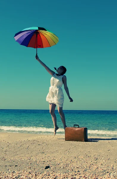 Model with umbrella and suitcase — Stock Photo, Image