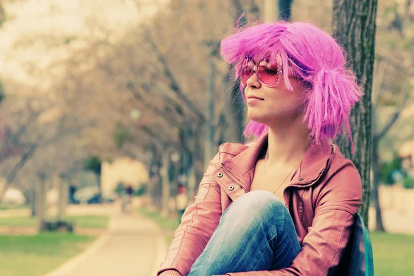 Beautiful young woman with pink sunglasses and purple hair — Stock Photo, Image