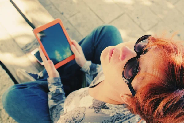 Mujer pelirroja con tableta al aire libre —  Fotos de Stock