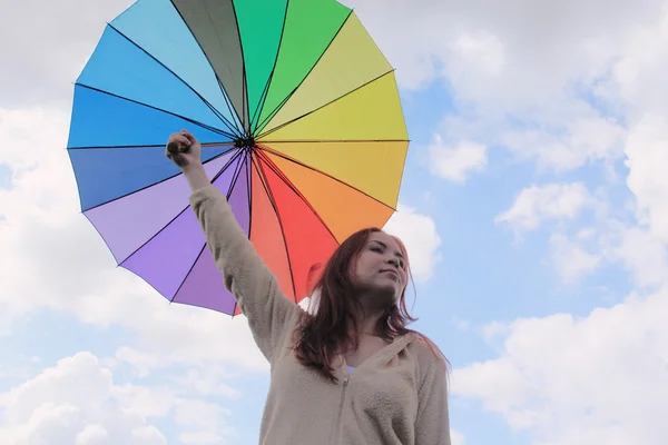 Žena s deštníkem na pozadí oblohy cloudly — Stock fotografie