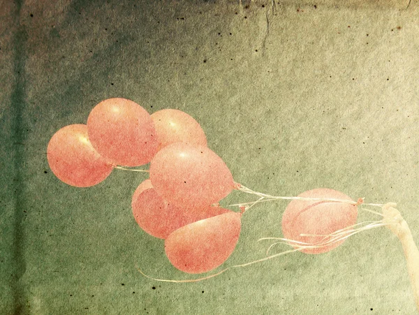 Red balloons on textured paper — Stock Photo, Image