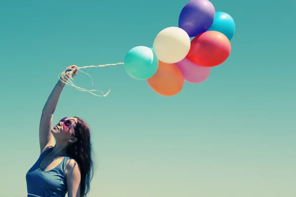 Jeune rousse femme tenant des ballons colorés — Photo