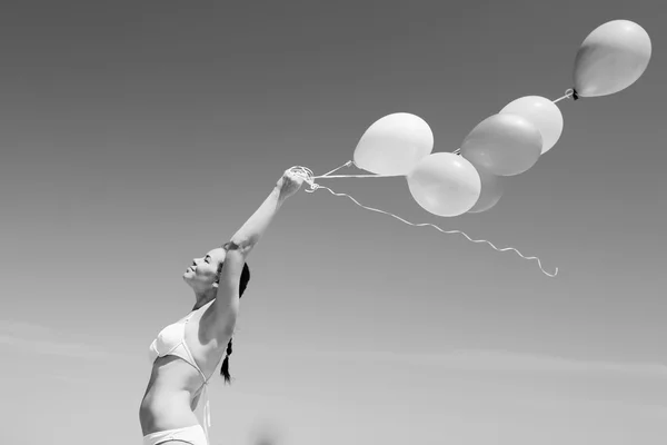 Young redhead woman holding balloons — Stock Photo, Image