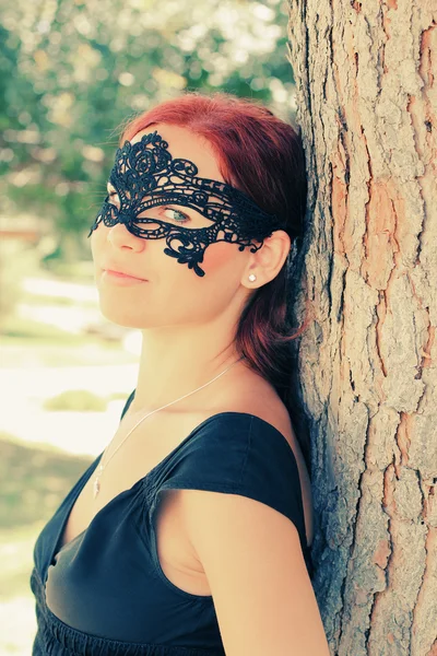 Portrait of beautiful woman in mask outdoors — Stock Photo, Image