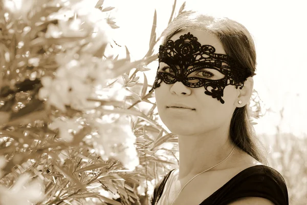 Portrait of beautiful woman in mask outdoors — Stock Photo, Image