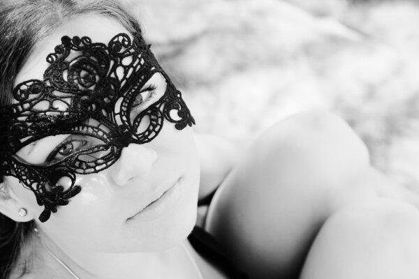 Portrait of beautiful woman in mask outdoors