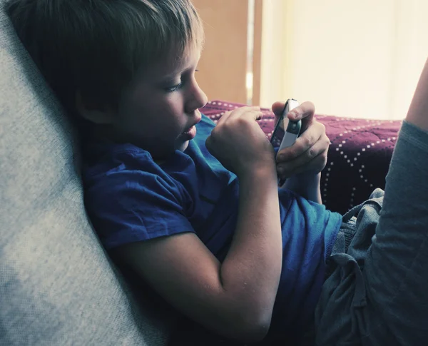 Cute boy using mobile phone — Stock Photo, Image