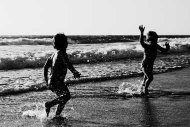 Kumsalda oynarken iki mutlu çocuk