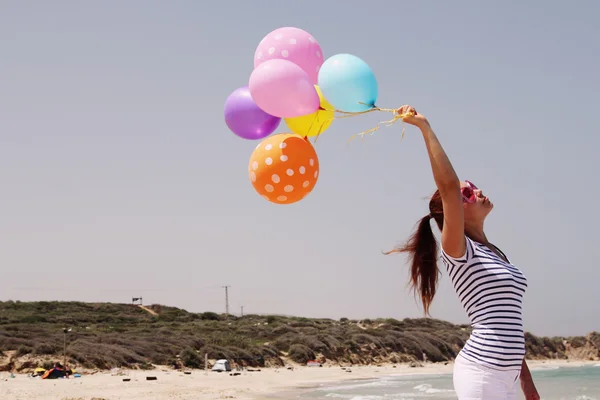 Красивая женщина с красочными воздушными шарами — стоковое фото