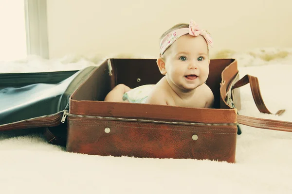 Baby lying in vintage bag — Stock Photo, Image