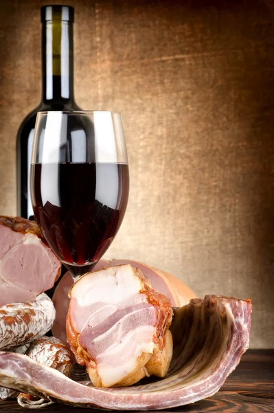 Wine and meat on a canvas — Stock Photo, Image