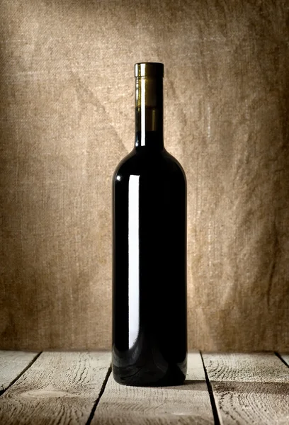 Black bottle of red wine — Stock Photo, Image