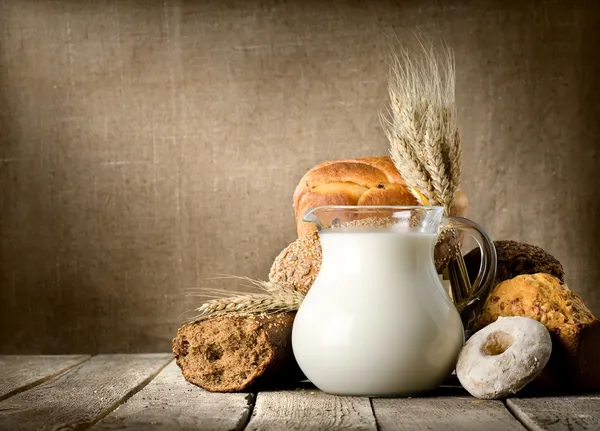Milk and bread on canvas — Stock Photo, Image