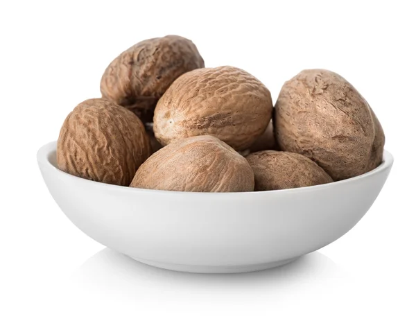Nutmegs in plate — Stock Photo, Image