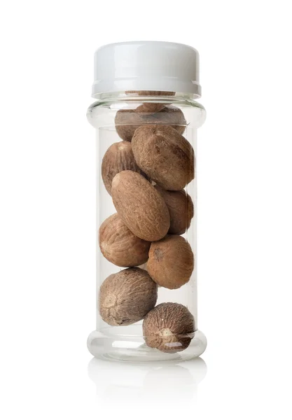 Nutmegs in a glass jar — Stock Photo, Image