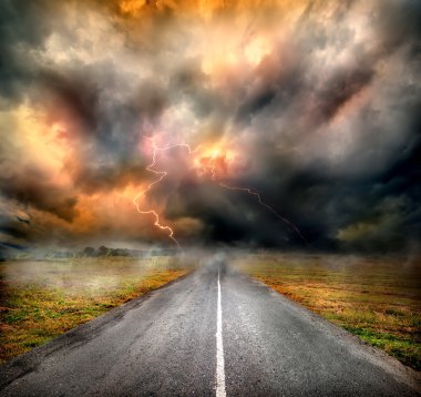 Storm clouds and lightning over highway clipart