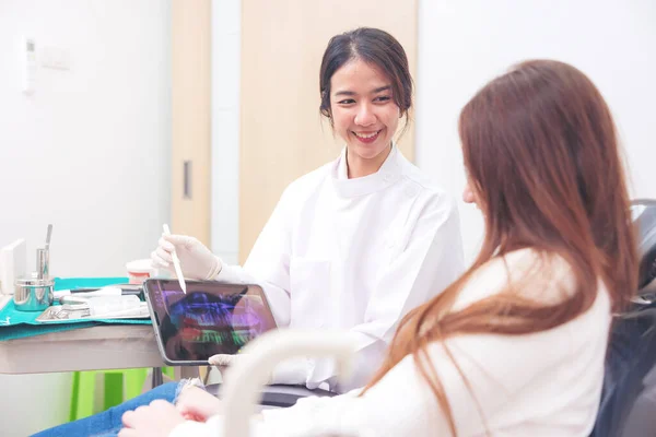 Podczas Konsultacji Dentysta Pacjent Omawiają Możliwości Leczenia Podczas Oglądania Cyfrowego — Zdjęcie stockowe