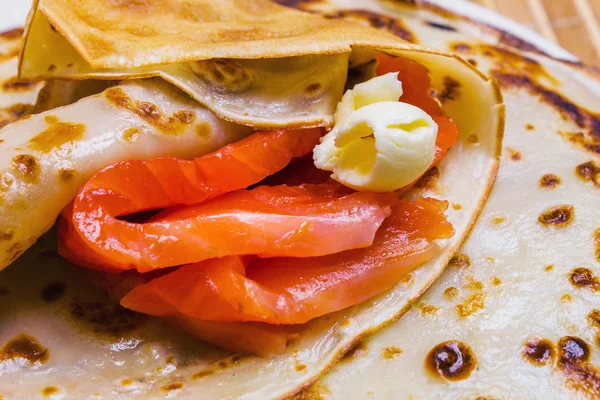 Pancakes with smoked salmon and butter on Shrovetide — Stock Photo, Image