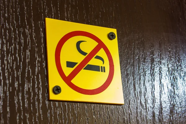 En skylt som förbjuder rökning på dörren — Stockfoto