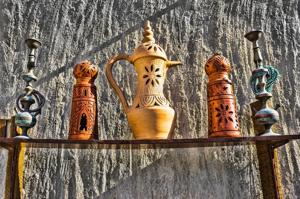 Eastern pitchers stand on a shelf in an Arab shop