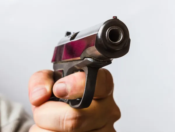 Man with a black gun in his hand — Stock Photo, Image