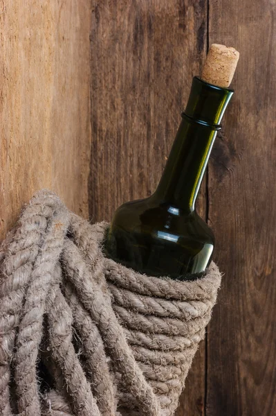 Bottle of wine wrapped with rope — Stock Photo, Image