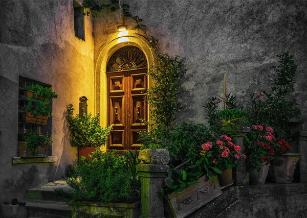 Door in house decorated with flowers — Stock Photo, Image