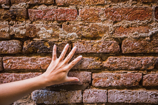 Hand touching wall
