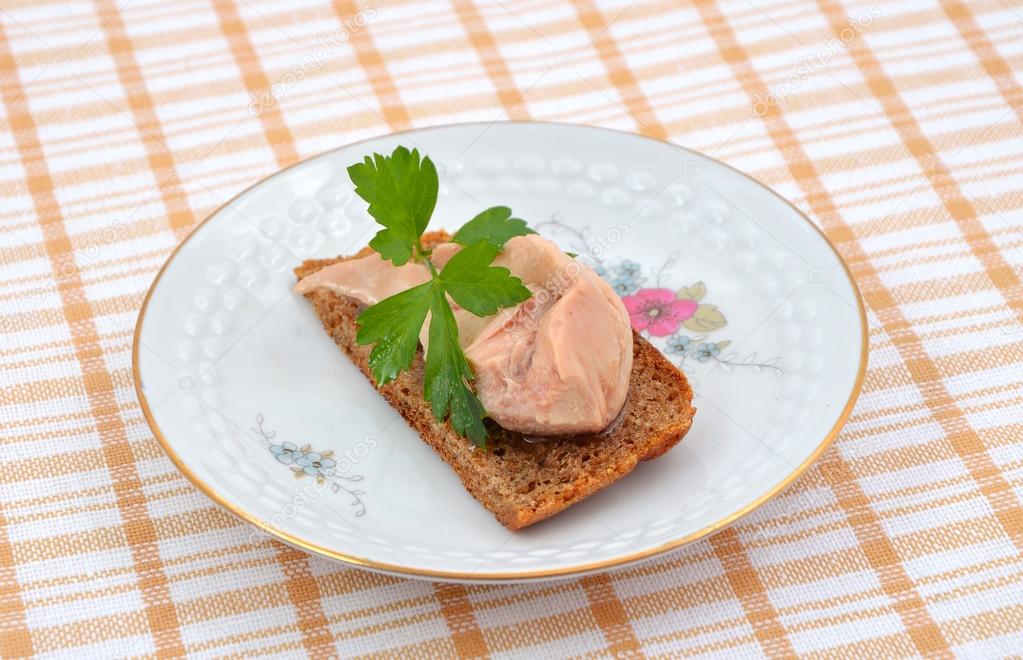 Small sandwich with a cod liver.