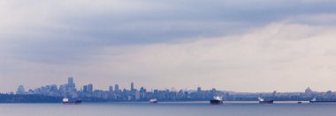 Oil tankers anchor Vancouver skyline BC Canada clipart