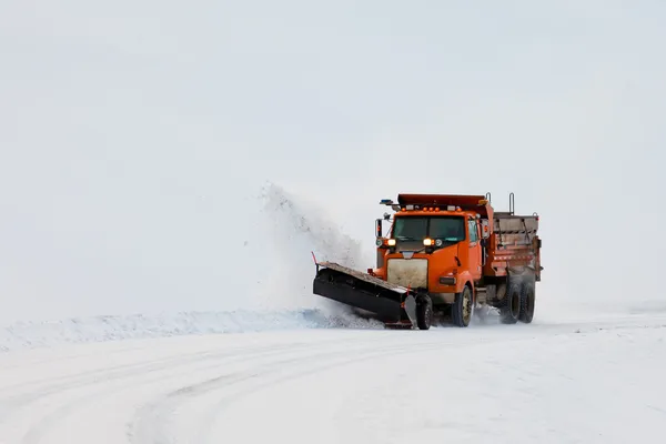 Snow plough clearing road in winter storm blizzard — Stock Photo, Image