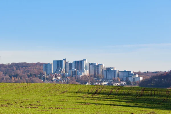 Urban high-rise apartment buildings on green field — Stock Photo, Image